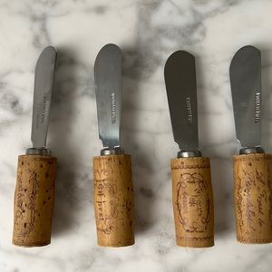 Set of four vintage cork stainless steel cheese spreaders.